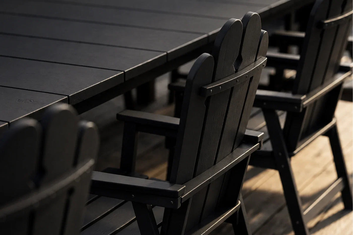 Black outdoor table and chairs on a wooden deck