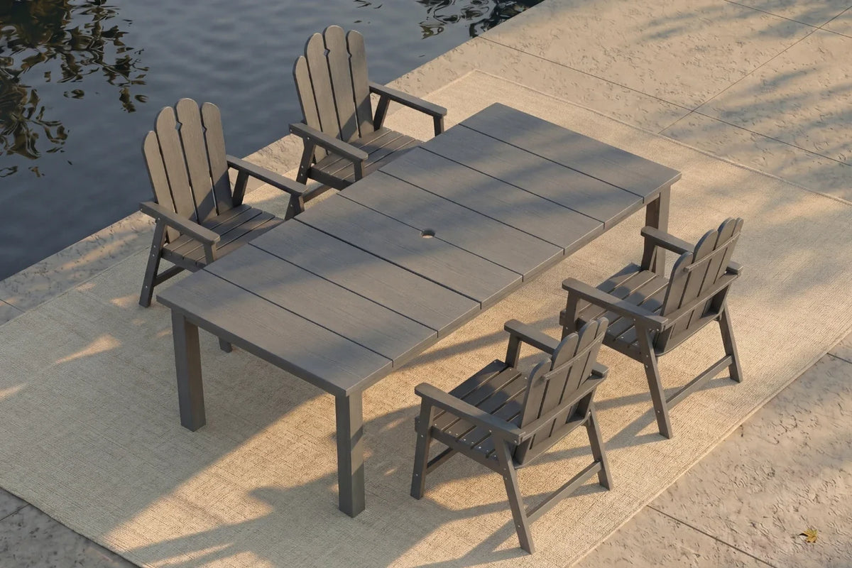 Dark gray Outdoor dining set with a large table and four chairs by a body of water.
