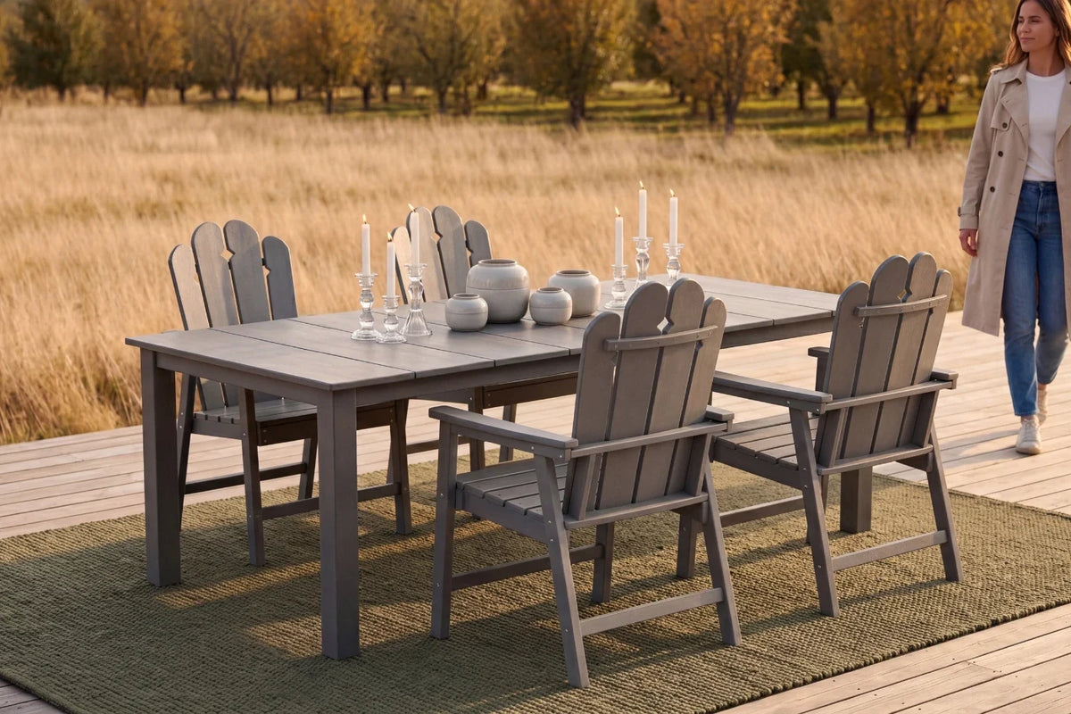 Dark gray Outdoor dining set with table and chairs on a wooden deck, woman walking in the background.