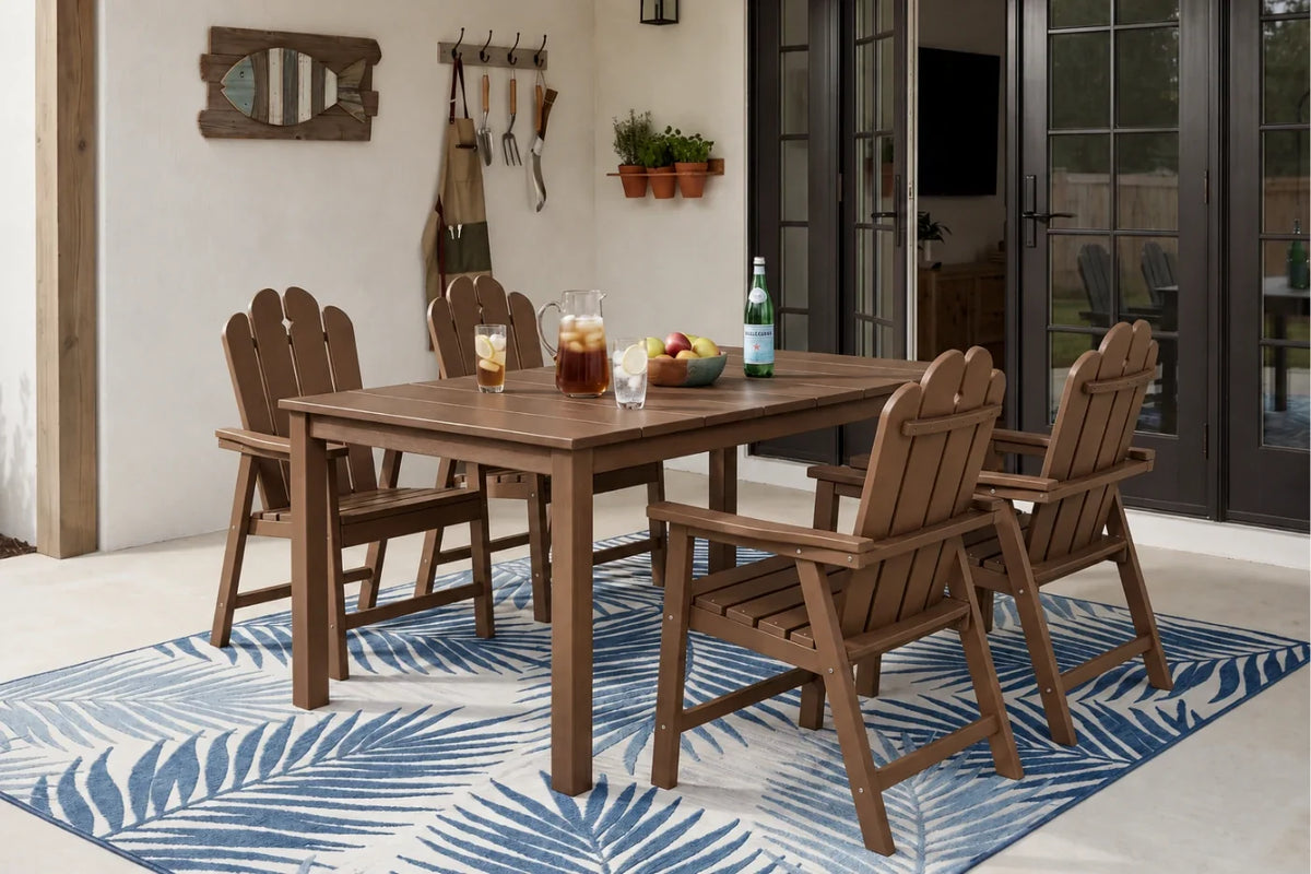 Light brown dining set with table and 4 chairs on a blue and white patterned rug in a room.