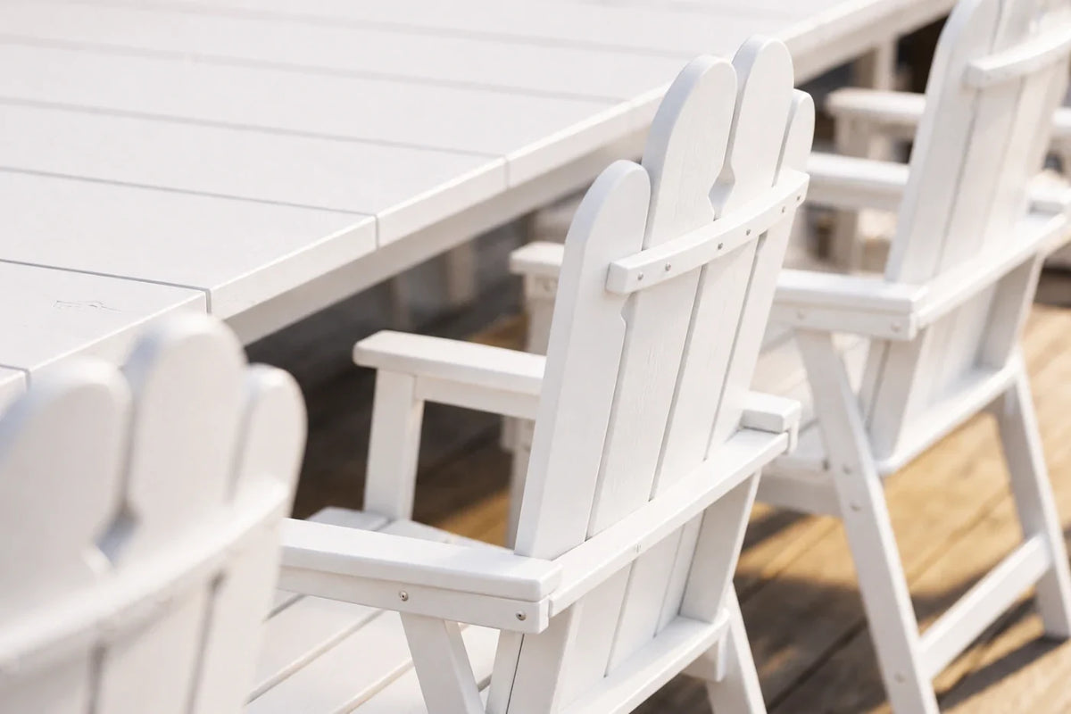 White outdoor chairs and table on a wooden deck