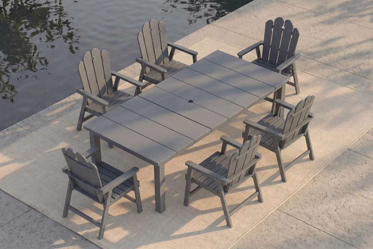 Gray Outdoor dining set with a table and chairs by a body of water.