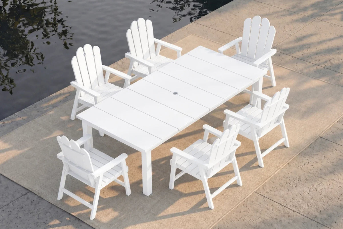 White outdoor table and chairs by a body of water