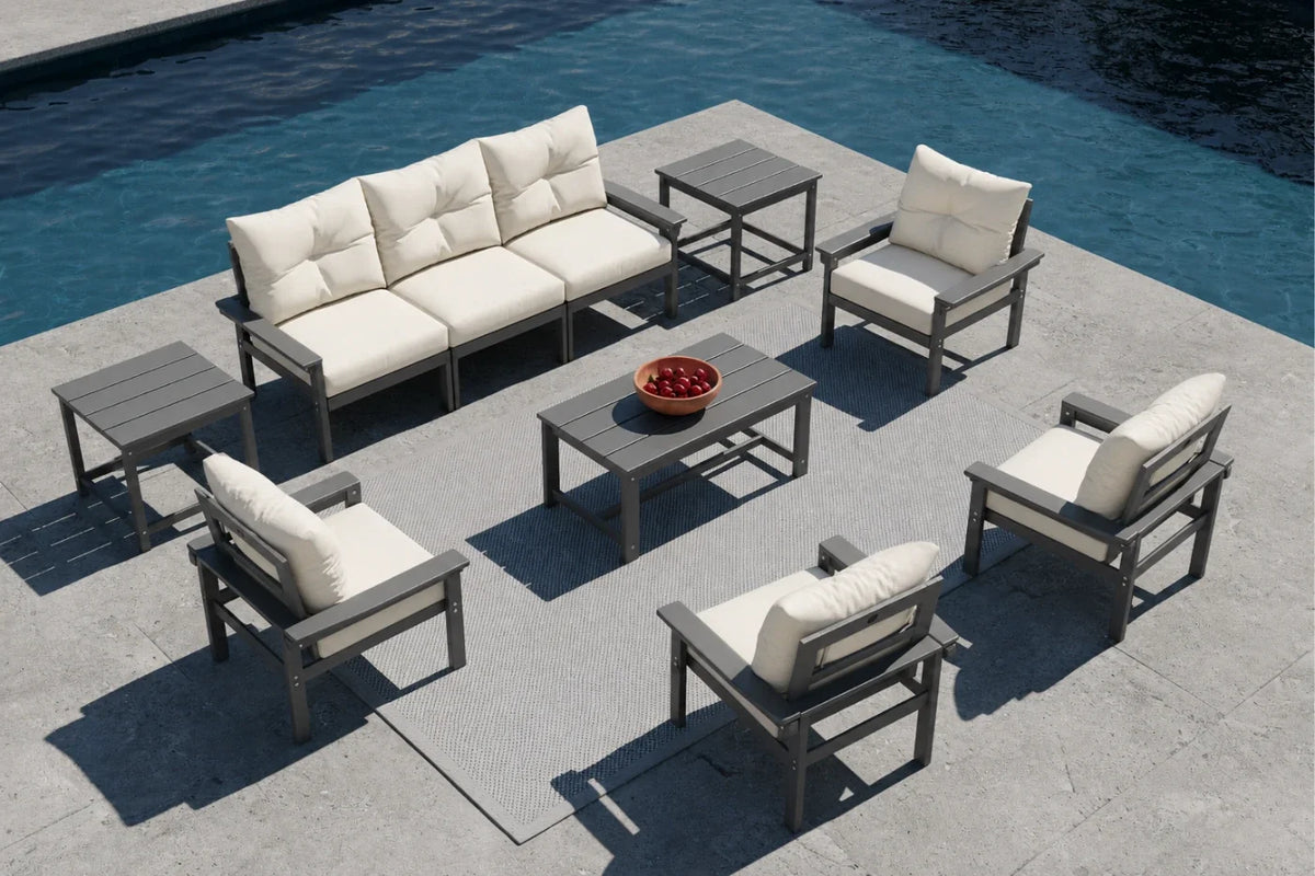 Outdoor patio furniture set with beige cushions by a pool