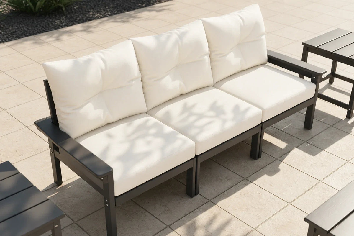 Outdoor patio set with white cushions on a tiled patio