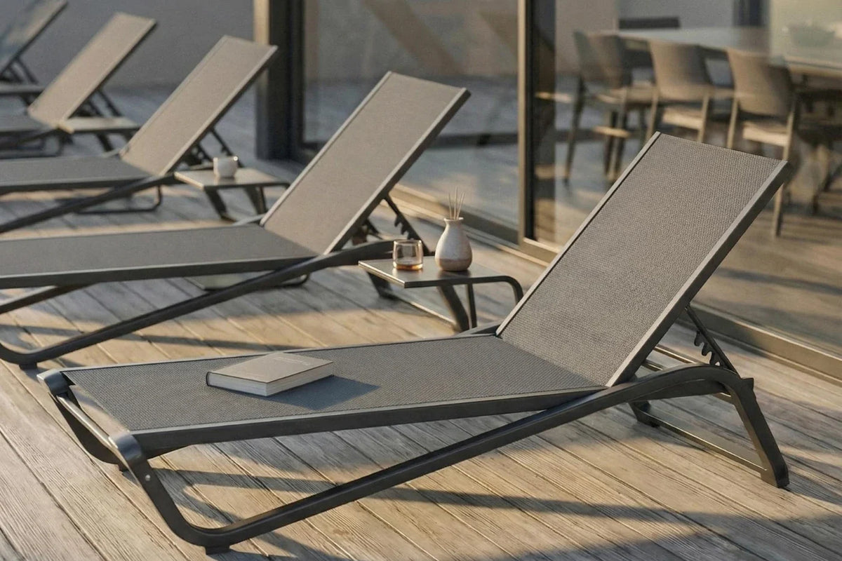 Sun loungers on a wooden deck with a blurred background