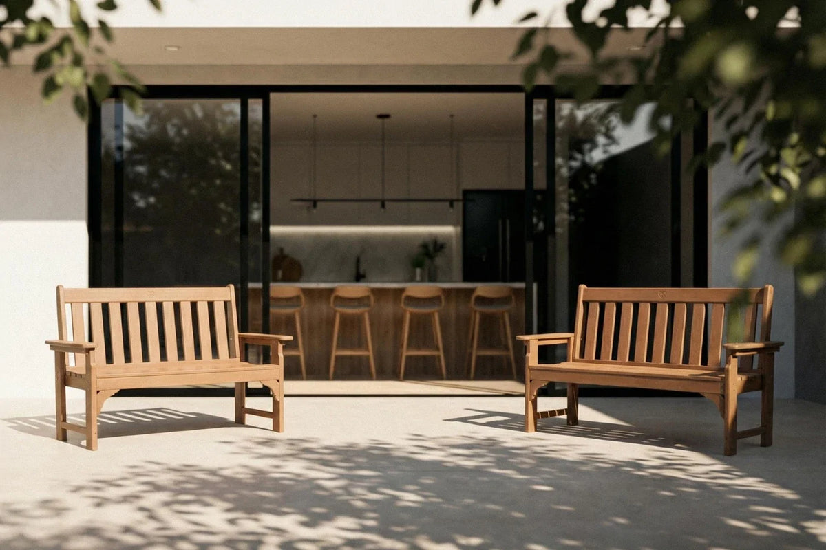 Two wooden benches in a modern outdoor setting with a house in the background.
