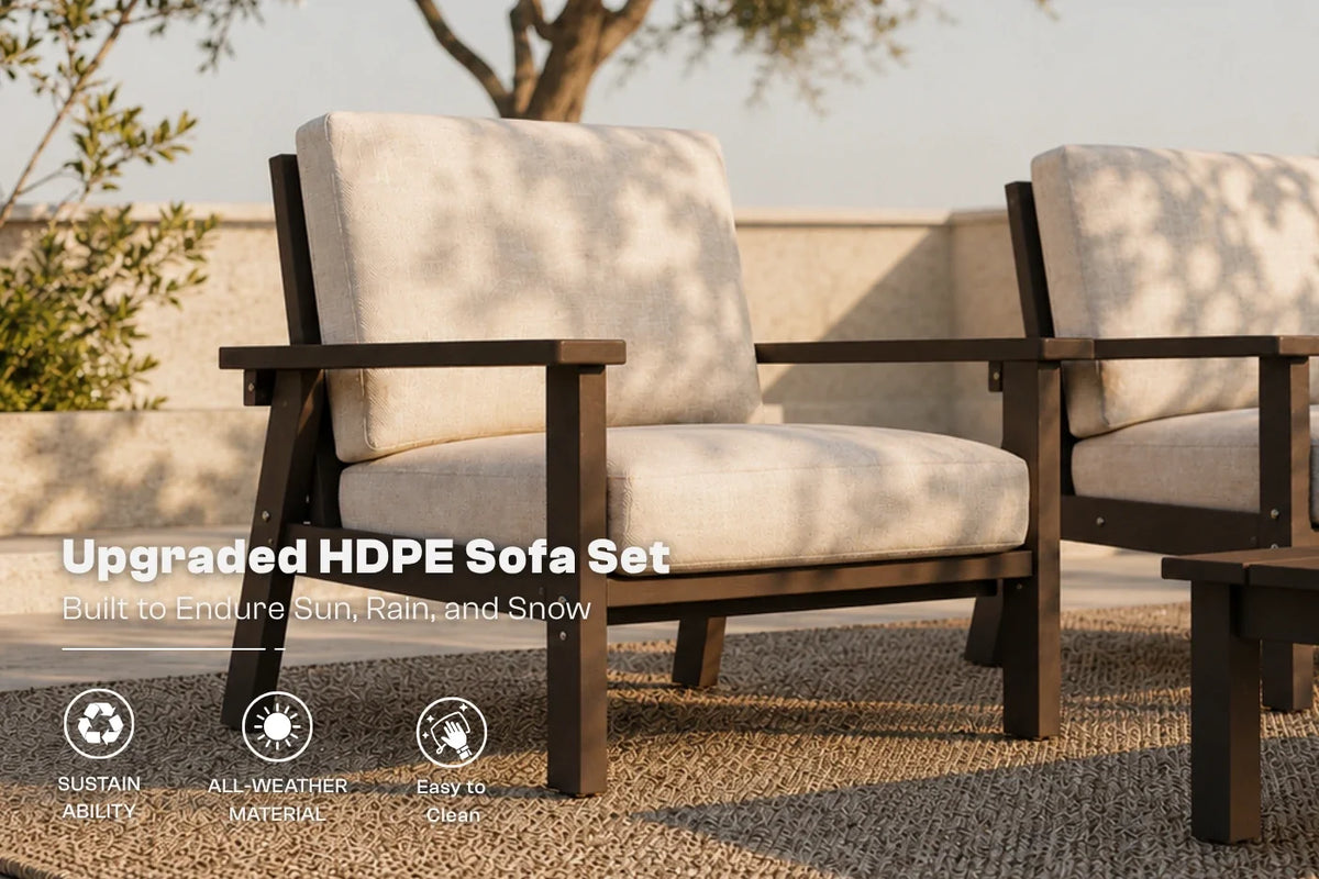 Outdoor patio armchairs with brown frames and creamy white cushions, shown on a woven rug with a wall and tree in the background. Text on the image reads 'Upgraded HDPE Sofa Set' with feature icons below.