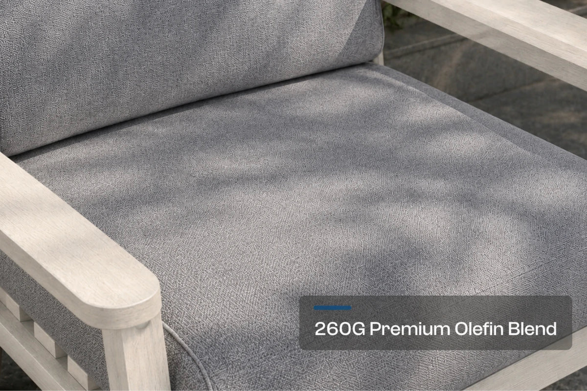 Close-up of a gray textured outdoor patio cushion on a creamy white framed chair, with a text overlay reading '260G Premium Olefin Blend'.