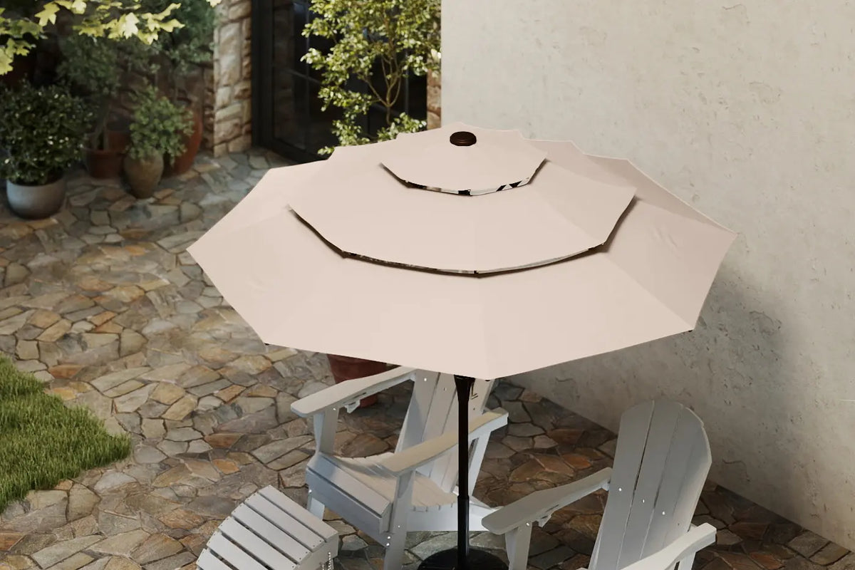 Beige patio umbrella over a table with chairs on a stone patio