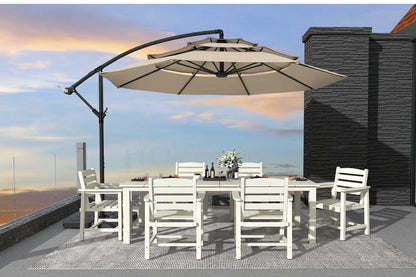 Outdoor dining set with a large umbrella on a rooftop with a cityscape view.
