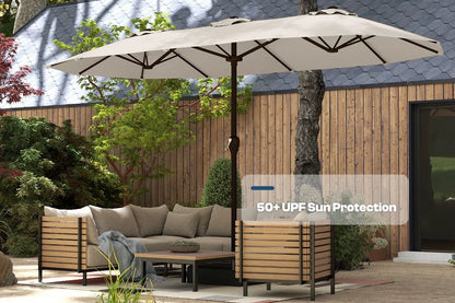 Outdoor patio set with a large umbrella providing shade, surrounded by greenery and a wooden fence.