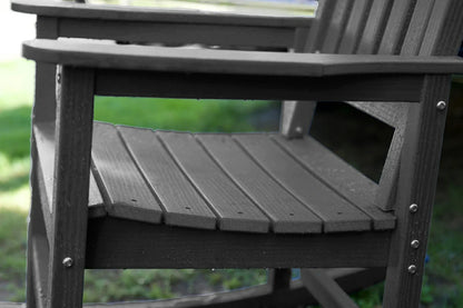 Dark gray wooden chair with a blurred green background