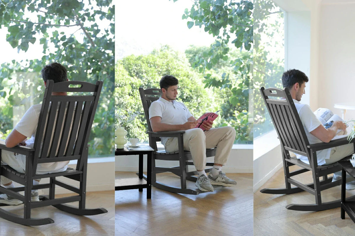 Man sitting in a rocking chair in a bright room with large windows.