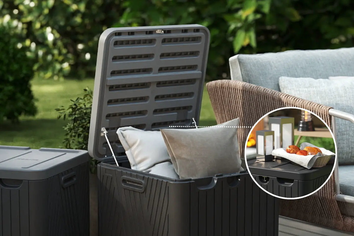 Outdoor storage bin with a lid open, showing cushions and a small table with items inside.