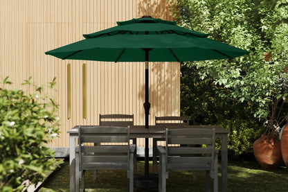 Outdoor patio set with table and chairs under a green umbrella in a garden setting.