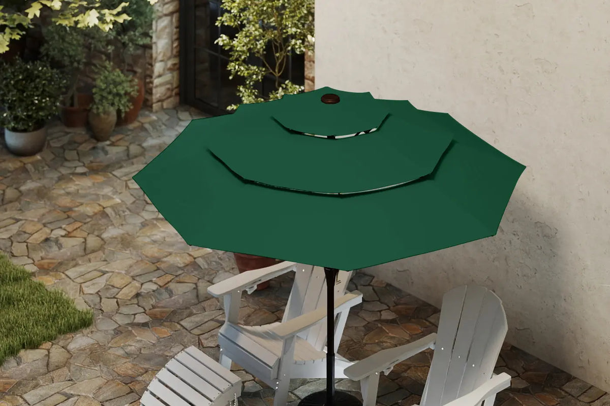Green patio umbrella on a stand with white chairs in an outdoor setting