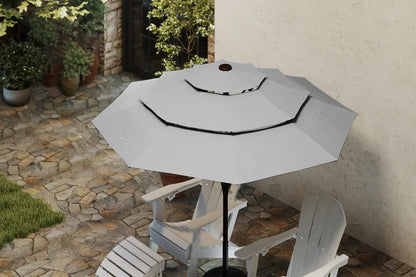 Gray patio umbrella on a stand with white chairs in a garden setting