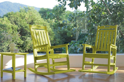 Two bright green rocking chairs on a wooden floor with a blurred natural background