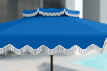 Blue outdoor umbrella with white trim on a blurred background