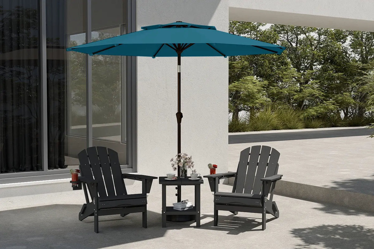 Outdoor patio set with two black chairs and a blue umbrella on a patio.
