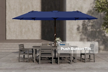 Blue patio umbrella with push button tilt feature over a dining set on a stone patio.