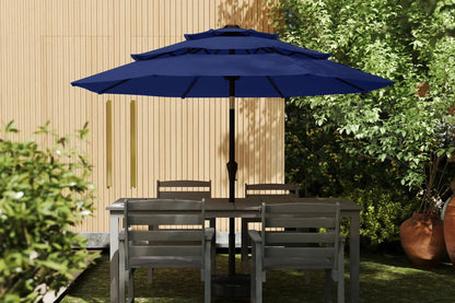 Outdoor patio set with table, chairs, and a large blue umbrella in a garden setting.