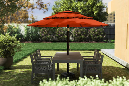 Outdoor patio set with a red umbrella in a garden setting