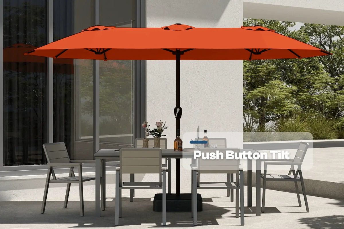 Outdoor dining set with a large orange umbrella on a patio.