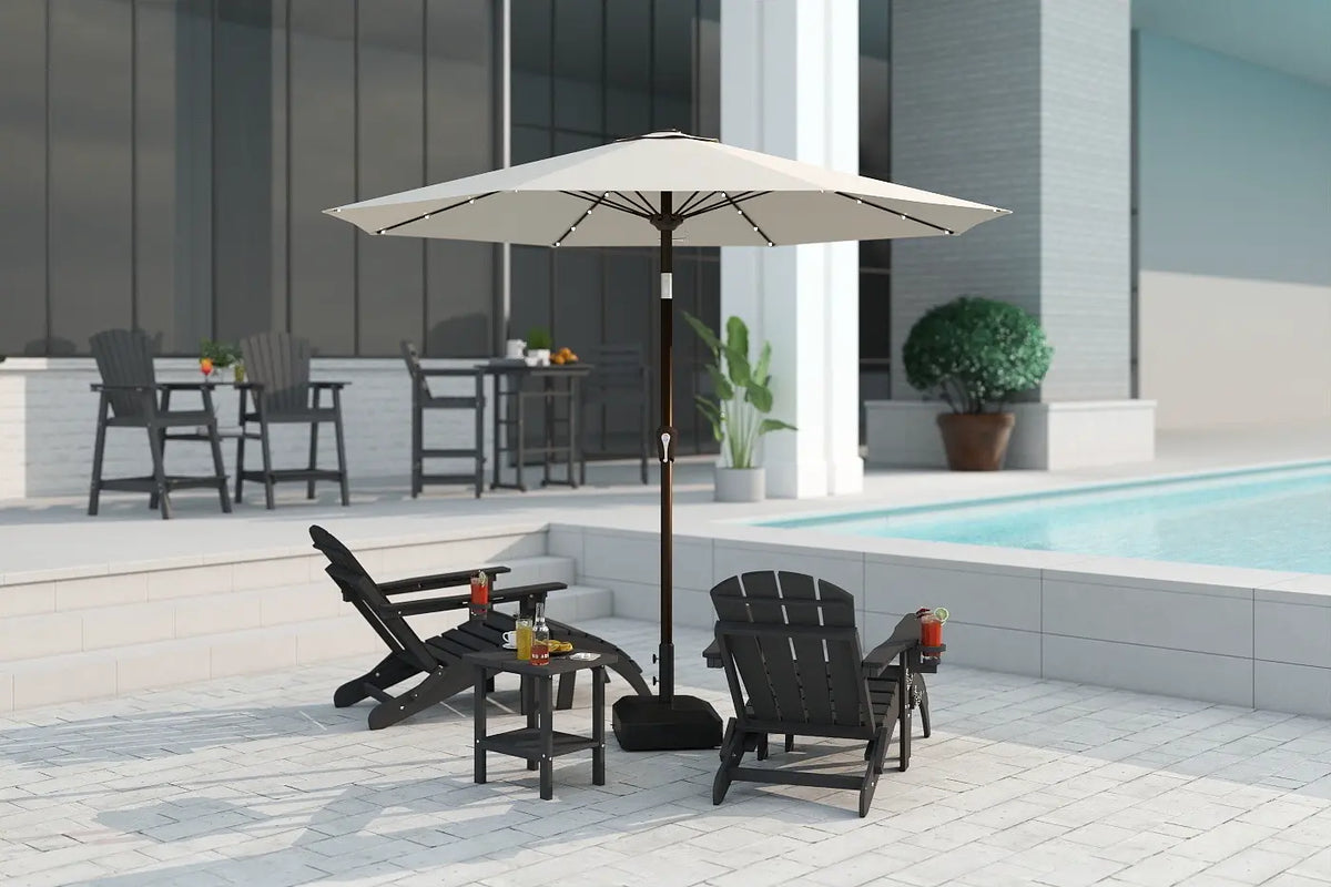 Outdoor patio set with umbrella, chairs, and table near a pool.