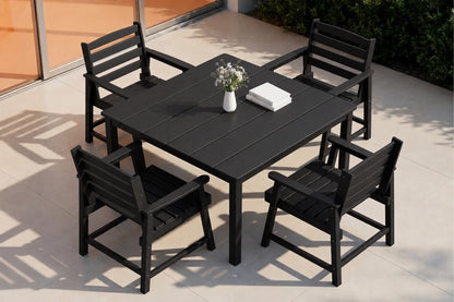 Black outdoor dining table with four chairs on a patio
