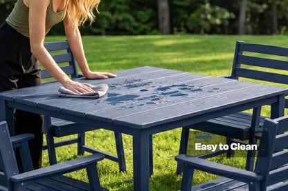 Person cleaning a blue outdoor table with 4 chairs in a grassy area, emphasizing ease of cleaning.