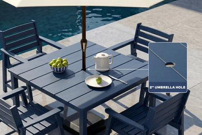 Blue Outdoor patio set with table, chairs, and umbrella hole feature near a pool.