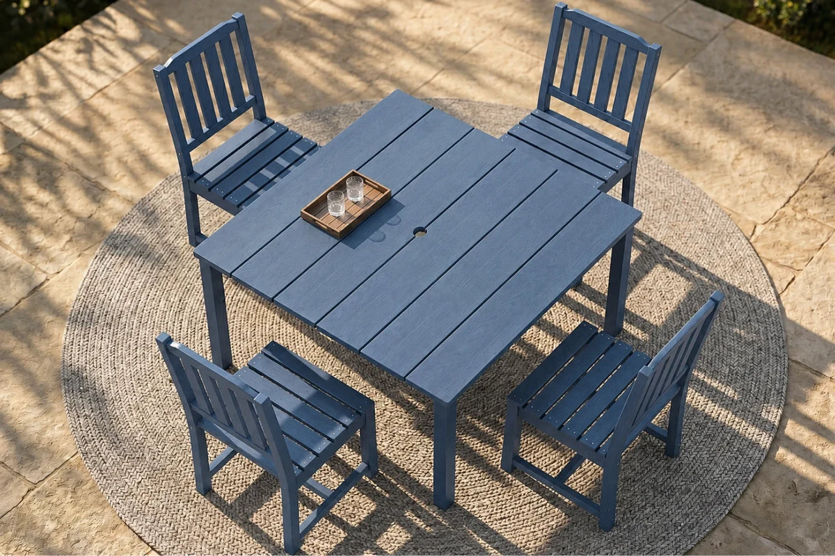 Blue outdoor table with four matching chairs on a stone patio.
