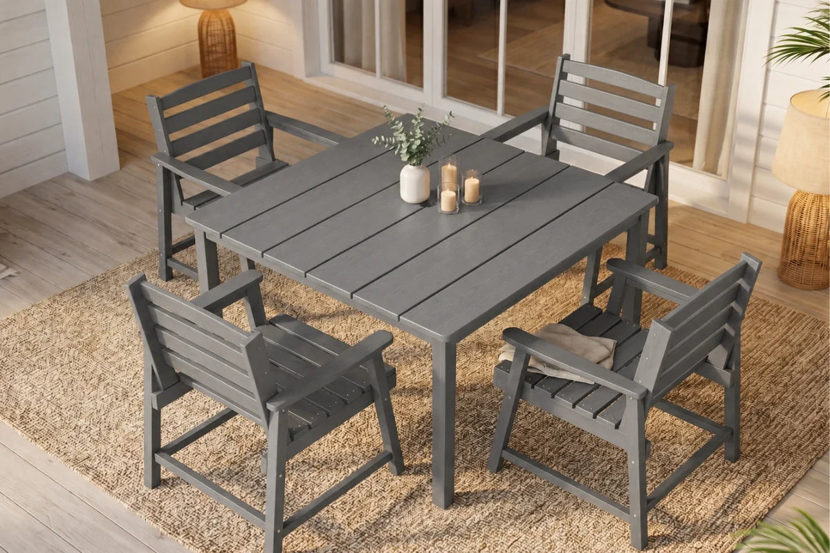 Gray outdoor dining table with four matching chairs on a wooden deck.