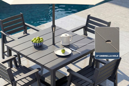 Gray Outdoor patio set with table, 4 chairs, and umbrella hole feature near a pool.