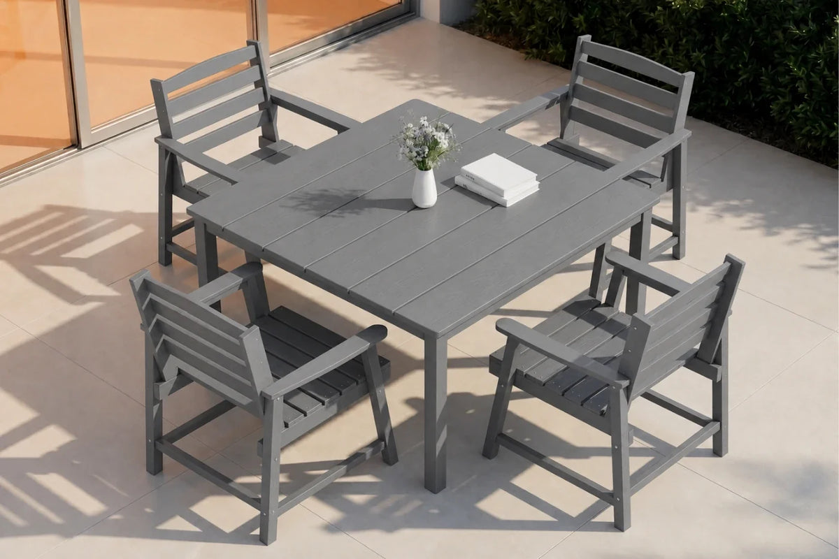 Gray outdoor dining table with four matching chairs on a patio.