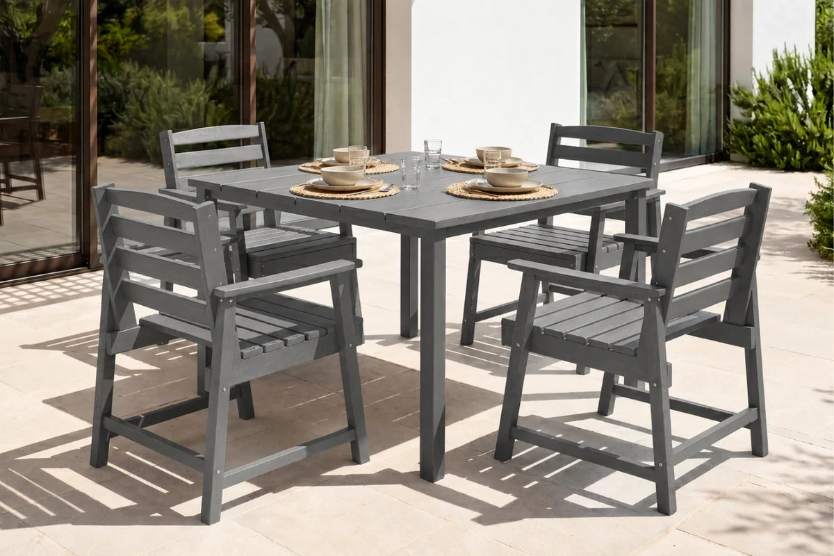 Gray outdoor dining table with four chairs on a patio.