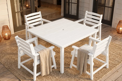 White outdoor table with four matching chairs on a wooden deck.