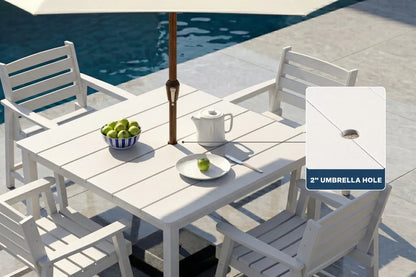 White outdoor dining set with table and 4 chairs by a pool, featuring an umbrella hole.