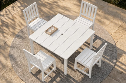 White outdoor table with four matching chairs on a patio.