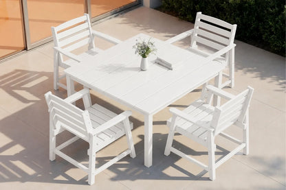 White outdoor table with four matching chairs on a patio.