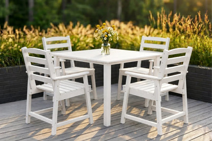 White outdoor dining set with four chairs on a wooden deck.