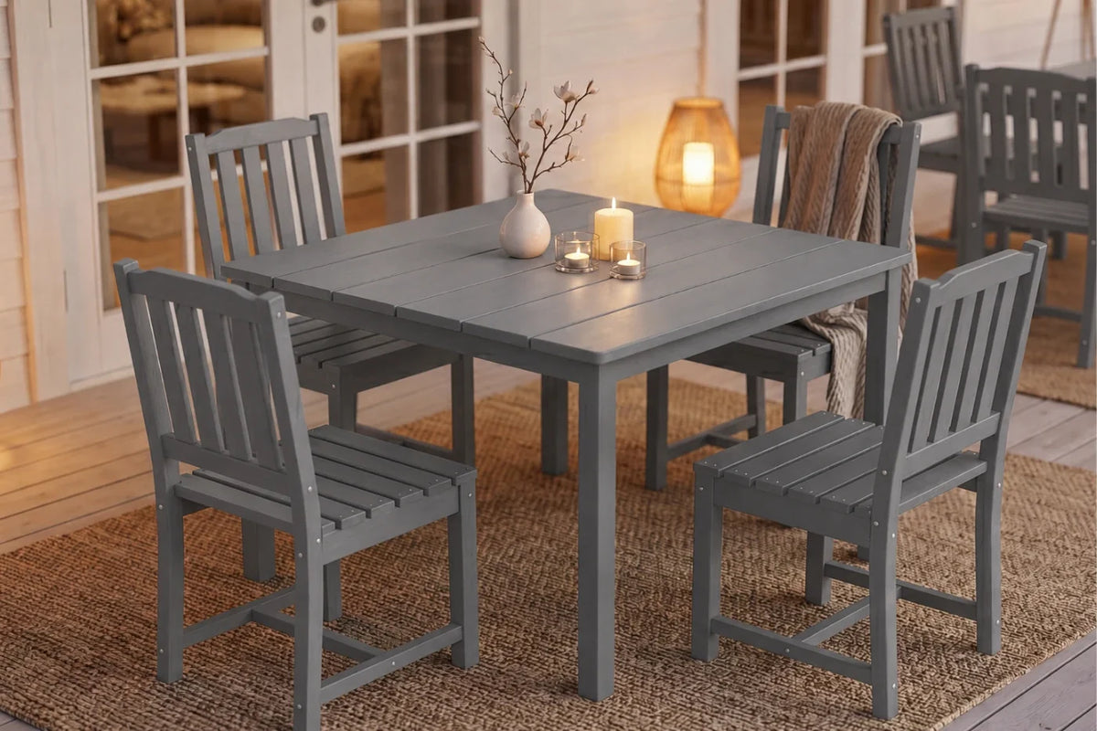 Gray outdoor dining table with 4 armless chairs on a wooden deck