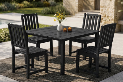 Black outdoor dining set with table and 4 armless chairs on a patio