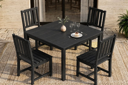Black outdoor dining set with table and 4 armless chairs on a patio.