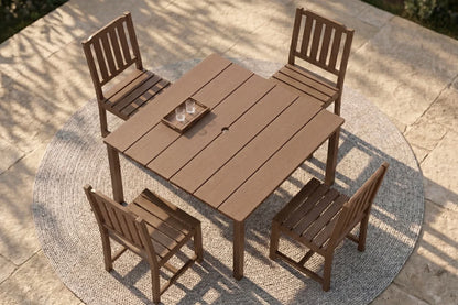 Brown outdoor table with four armless chairs on a patio