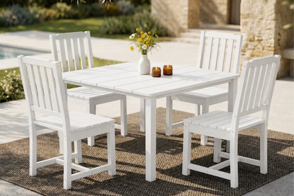 White outdoor dining set with four armless chairs on a patio.