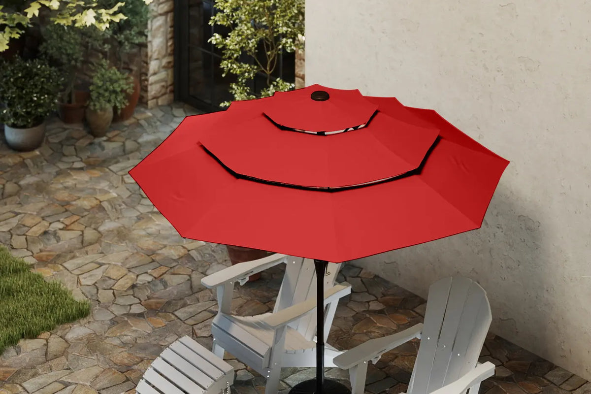 Red patio umbrella on a stand with white chairs in an outdoor setting