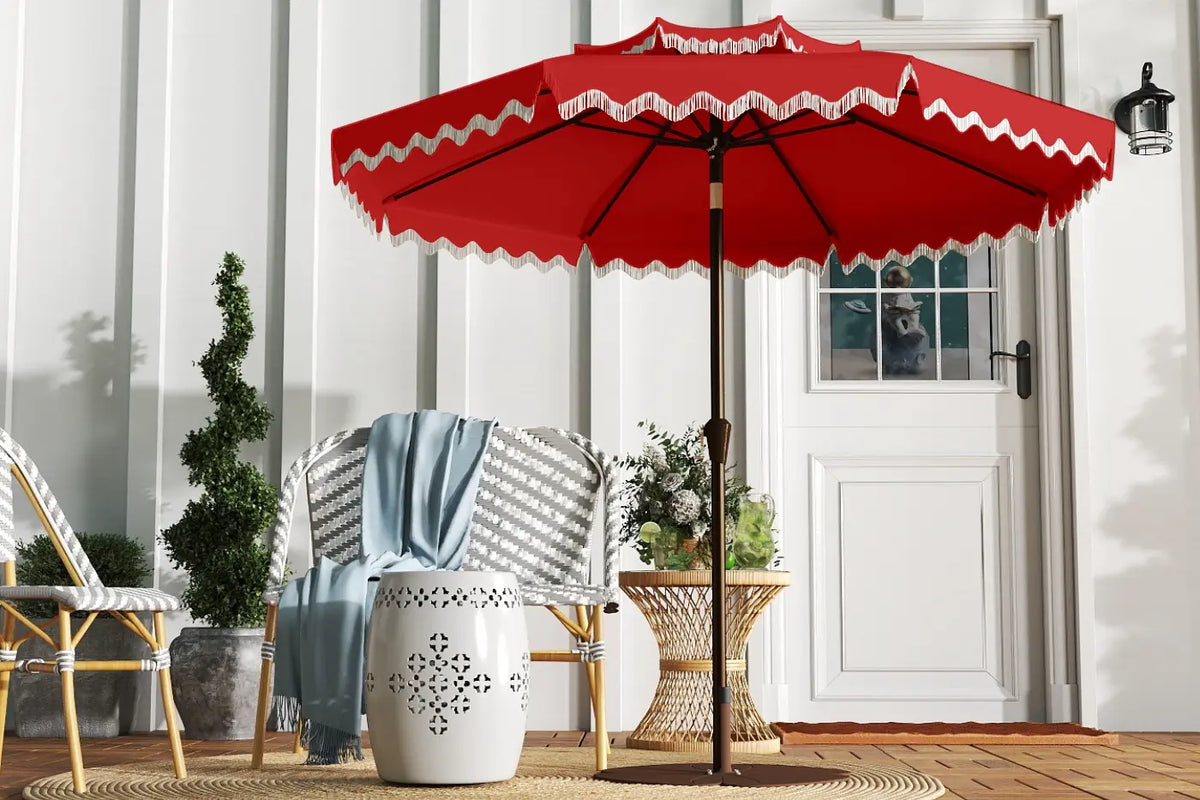 Red patio umbrella with white trim on a wooden deck
